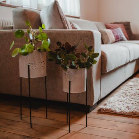 Stehender grauer Keramiktopf mit Metallbeinen und schwarzem Brennmuster