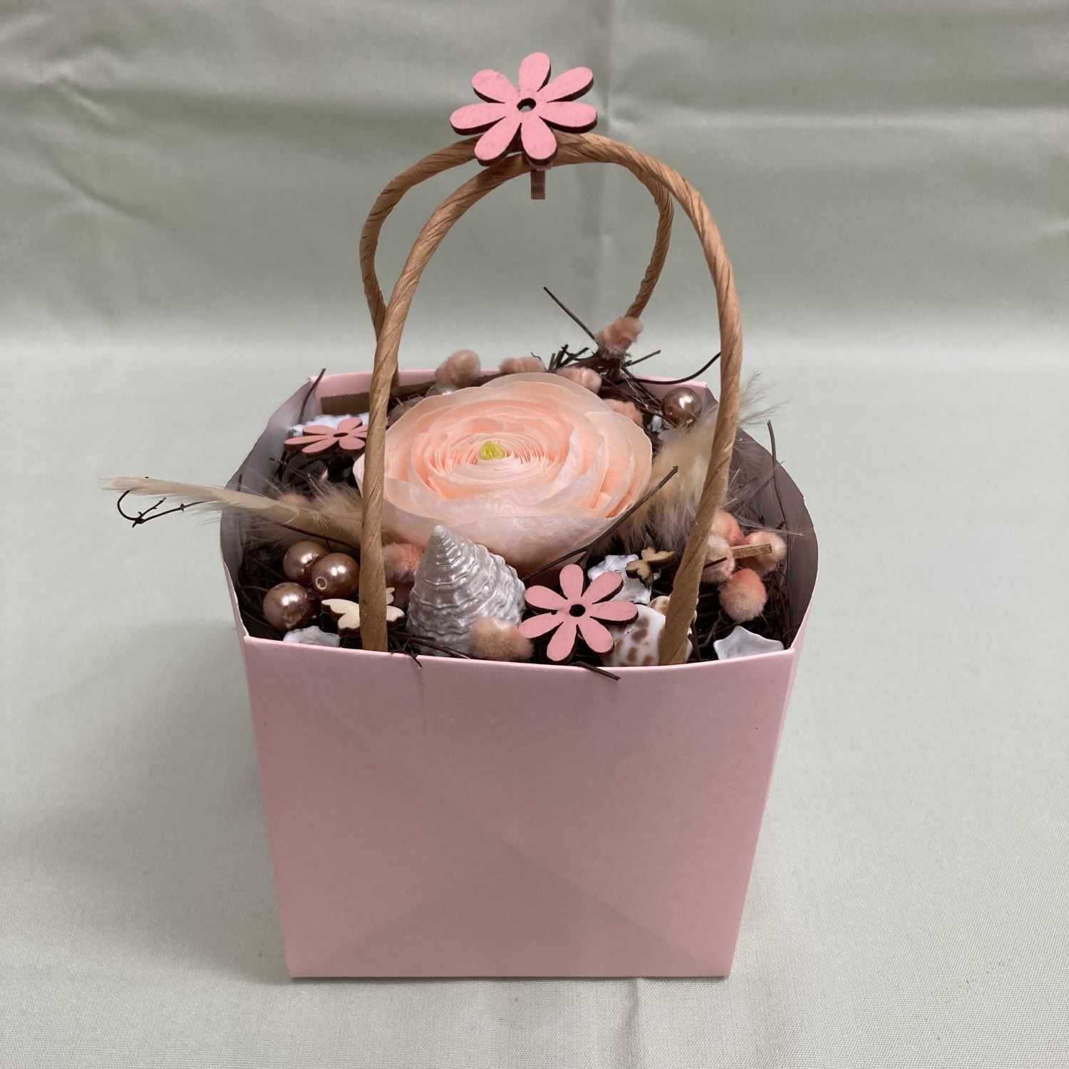 Arrangement mit stabilisierter Ranunkel in Tasche